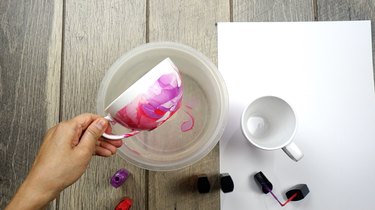 Nail polish marbled mug with multi-colored design.
