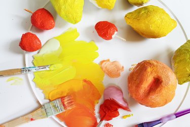 Painting papier-mache fruits