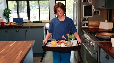 person holding breakfast tray with stuffed French toast