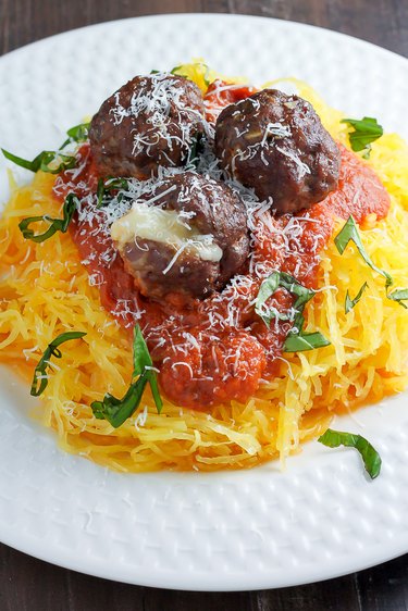 Shredded spaghetti squash used as a base for meatballs and sauce.