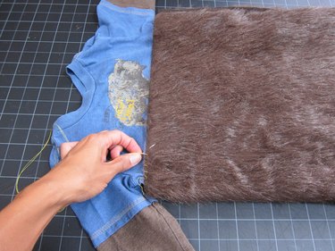 Sewing fur to shirt.