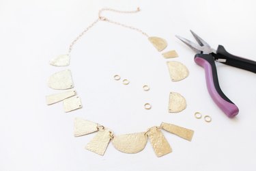 Link shapes together to create a necklace
