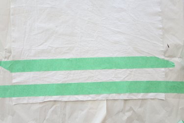 Form a stripe by covering canvas with painter's tape.