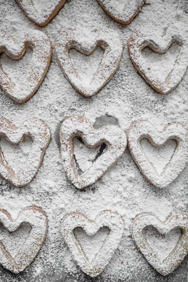 Sift the powdered sugar over the cut-out cookies.