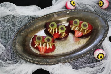 Three apple monsters arranged on a platter