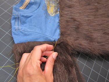 Sewing fur to arms.