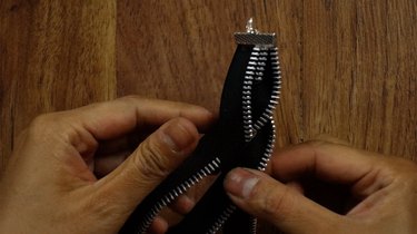 Braiding zippers to make a braided bracelet.