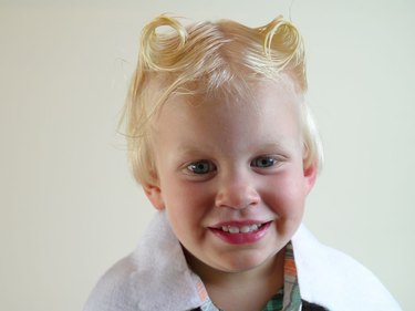 Little boy with his hair in two twists.