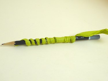 The wrapped wire coiled around a pencil.