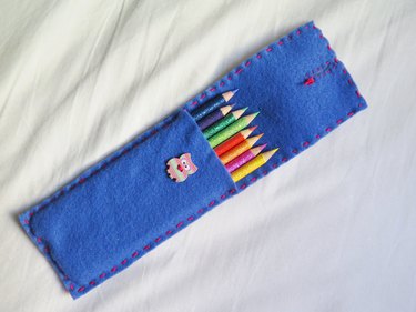 The flap left opened to show the back of the embroidered slit.