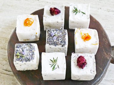 eight bath bombs in various scents displayed on a wood platter