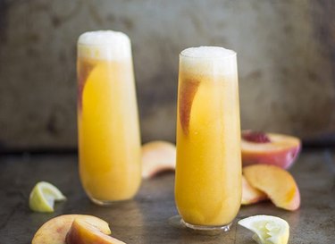 peach bellinis in cocktail glasses