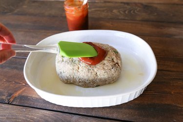 Meatloaf with sauce being spread on top