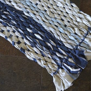 Woven rag rug using cardboard loom.