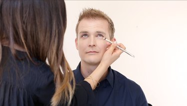 Applying concealer under eyes with concealer brush