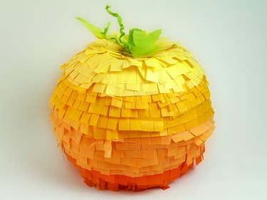 A large pumpkin piñata with 5 different shades of orange tissue.