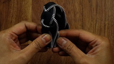 Braiding zippers to make a braided bracelet.