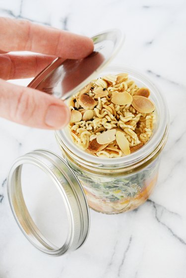Use an apple sauce cup to store nuts or dressing inside of a wide mouth mason jar.