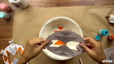 Using stencil to paint DIY desert-style baskets.