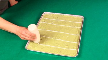 tray of guacamole with sour cream lines