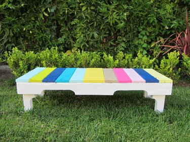 Pallet transformed into a colorful bench