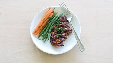 Honey balsamic chicken plated with carrots and green beans