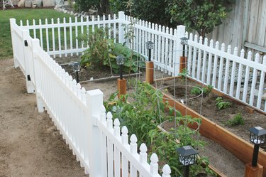 white fence surrounding a garden