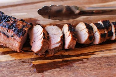 Grilled pork tenderloin on a cutting board