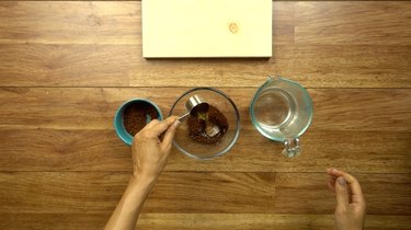 Mixing instant coffee and hot water for easy way to stain wood with coffee.