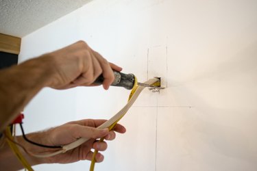 Use a drywall saw to cut the drywall