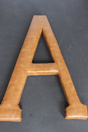 Front of letter "A" monogram completely covered in faux leather fabric
