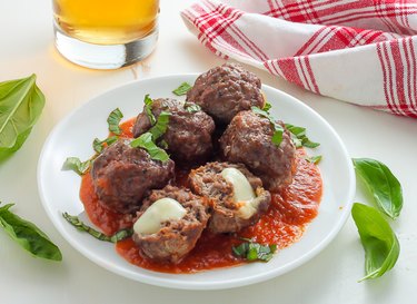 Meatballs covered in roasted garlic tomato sauce.
