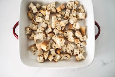 Cover the baking dish with the cubed bread.