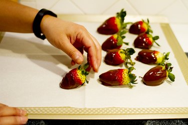 Place dipped strawberry on cookie sheet