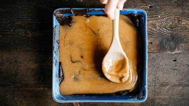 Spread the salted caramel over the bottom layer of brownie batter.
