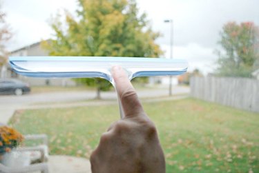 Use a squeegee to wipe away window cleaner.
