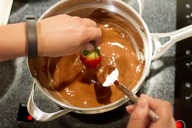 Dip strawberry into chocolate