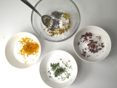 Four mixing bowls with the different added ingredients.