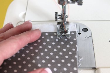 guide the fabric with hands as you sew