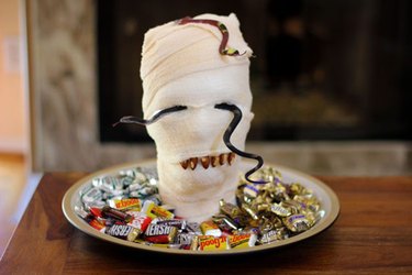 A fake mummy head on a candy platter