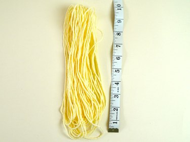 Pile of yarn loops and measuring tape.