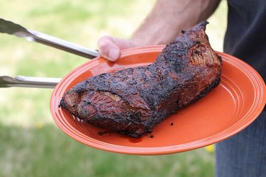 Man holding a plate of tri-tip