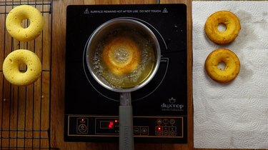 Deep frying healthy coconut flour low carb donuts.