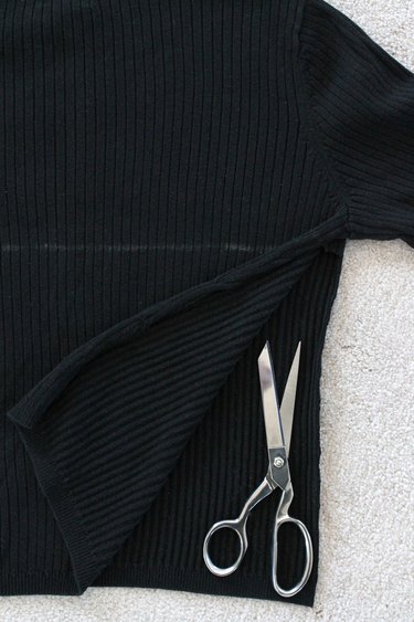 Cut the side seams of the sweater open up to the mark.