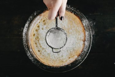 Generously dust the top of the Dutch Baby pancake with the powdered sugar.