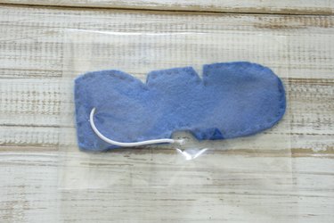 "DAD" design felt car air freshener with elastic loop tie, inside of cellophane party bag or pouch,  with one end folded over and taped closed.