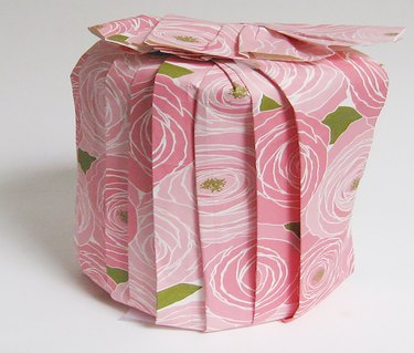 round gift wrapped with pleated paper