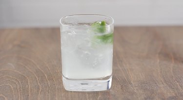 gin and tonic with lime wedge garnish