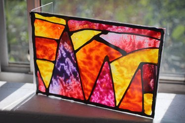 an acrylic picture frame housing a melted crayon design