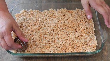Cutting Krispies with biscuit cutter.